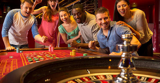 Group Of Friends Playing Roulette In Casino