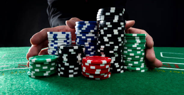 Businessman hands pushing gambling chips.