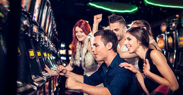 Group of people playing slot machines