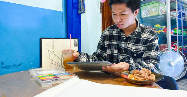 young men using tablet computer doing homework