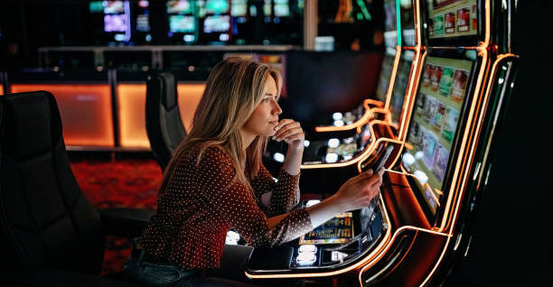Women gambling on slot machinery